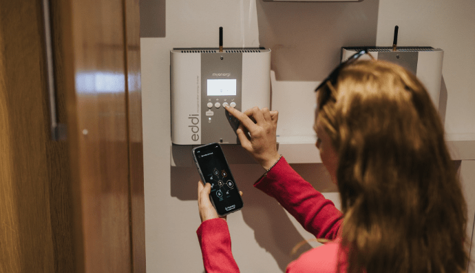 Woman setting up her eddi | myenergi Ireland