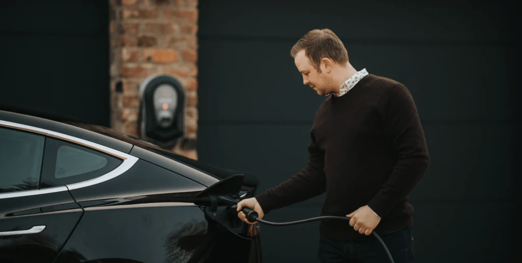 A photo of a male connecting his zappi charger