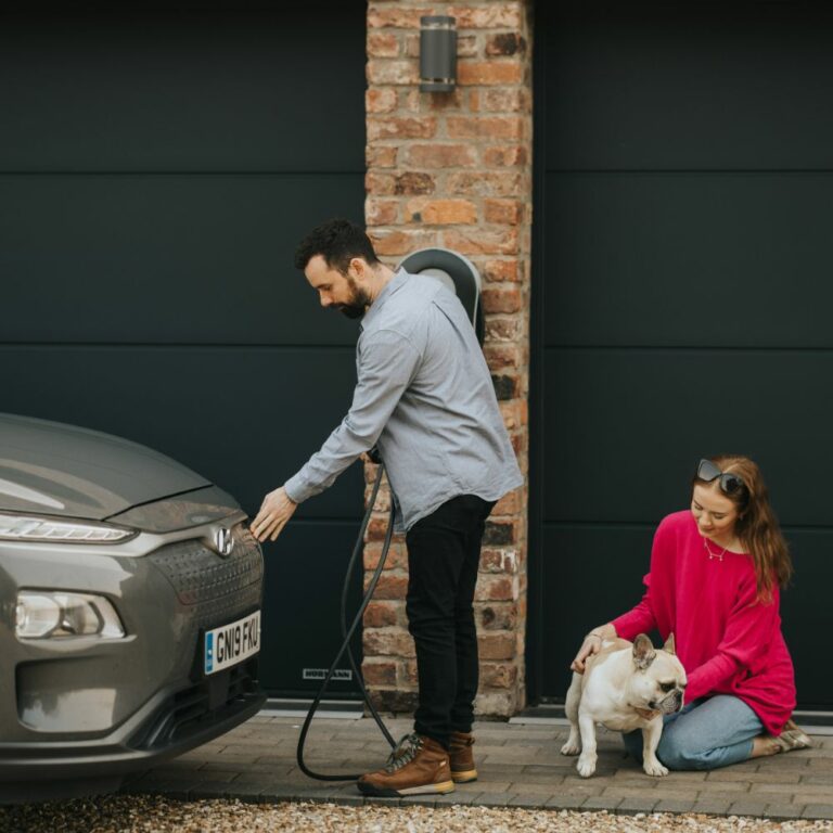 A family plugging in their zappi EV charger
